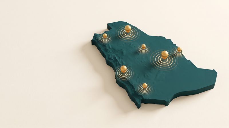 A three-dimensional teal map of Saudi Arabia with gold pins marking regions served.